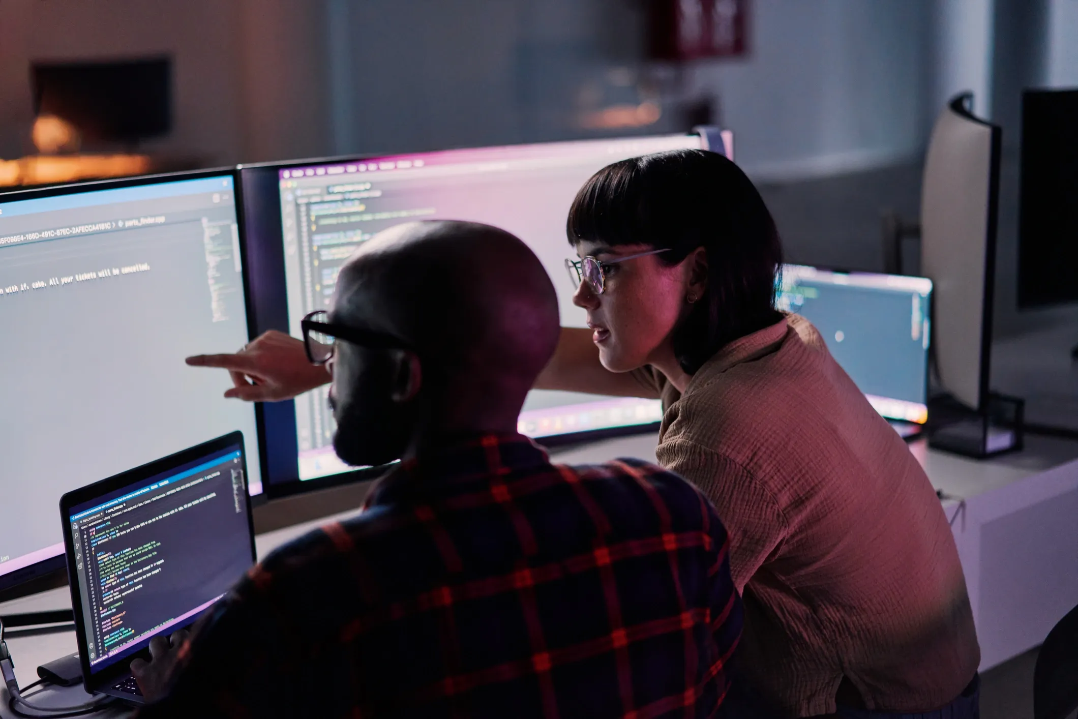 Developers collaborating at computer monitors